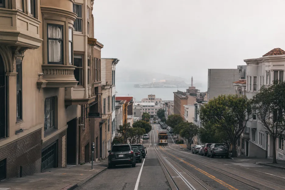 San Francisco neighborhood storefronts on a fog-softened hillside street